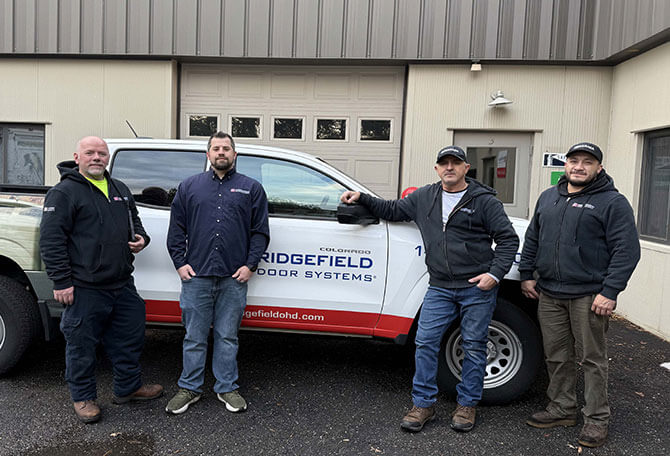 Technicians in front of a truck services of Ridgefield Door Systems in Danbury